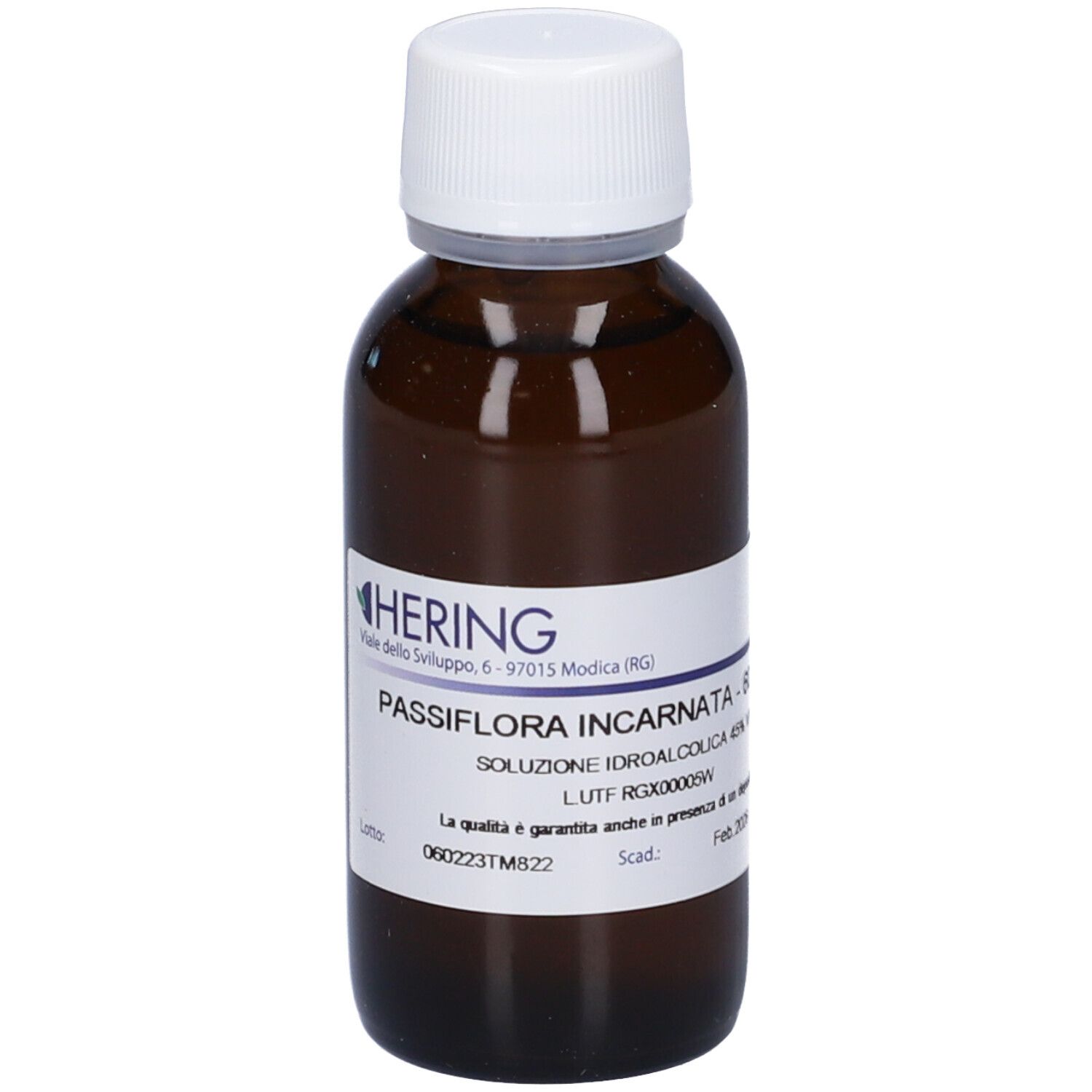 Flacone di vetro marrone con tappo bianco. Etichetta con nome del prodotto e informazioni. Marca: Hering.