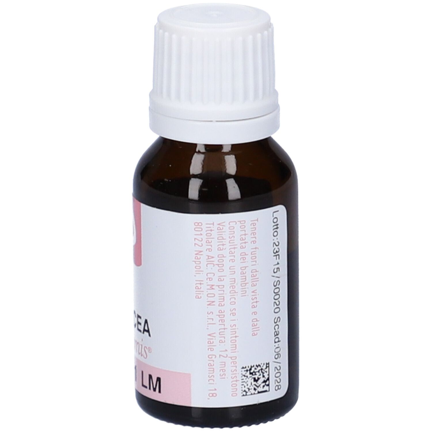 Flacone in vetro marrone con tappo bianco. Etichetta rosa con testo e numero di lotto.