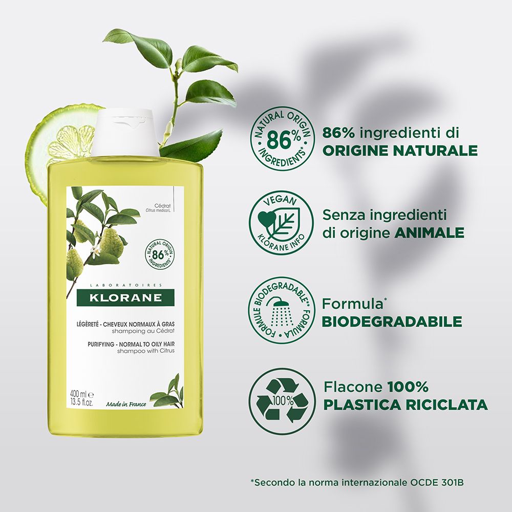 Flacone shampoo Klorane con agrumi e foglie. Testo: 86% ingredienti naturali, vegano, biodegradabile.