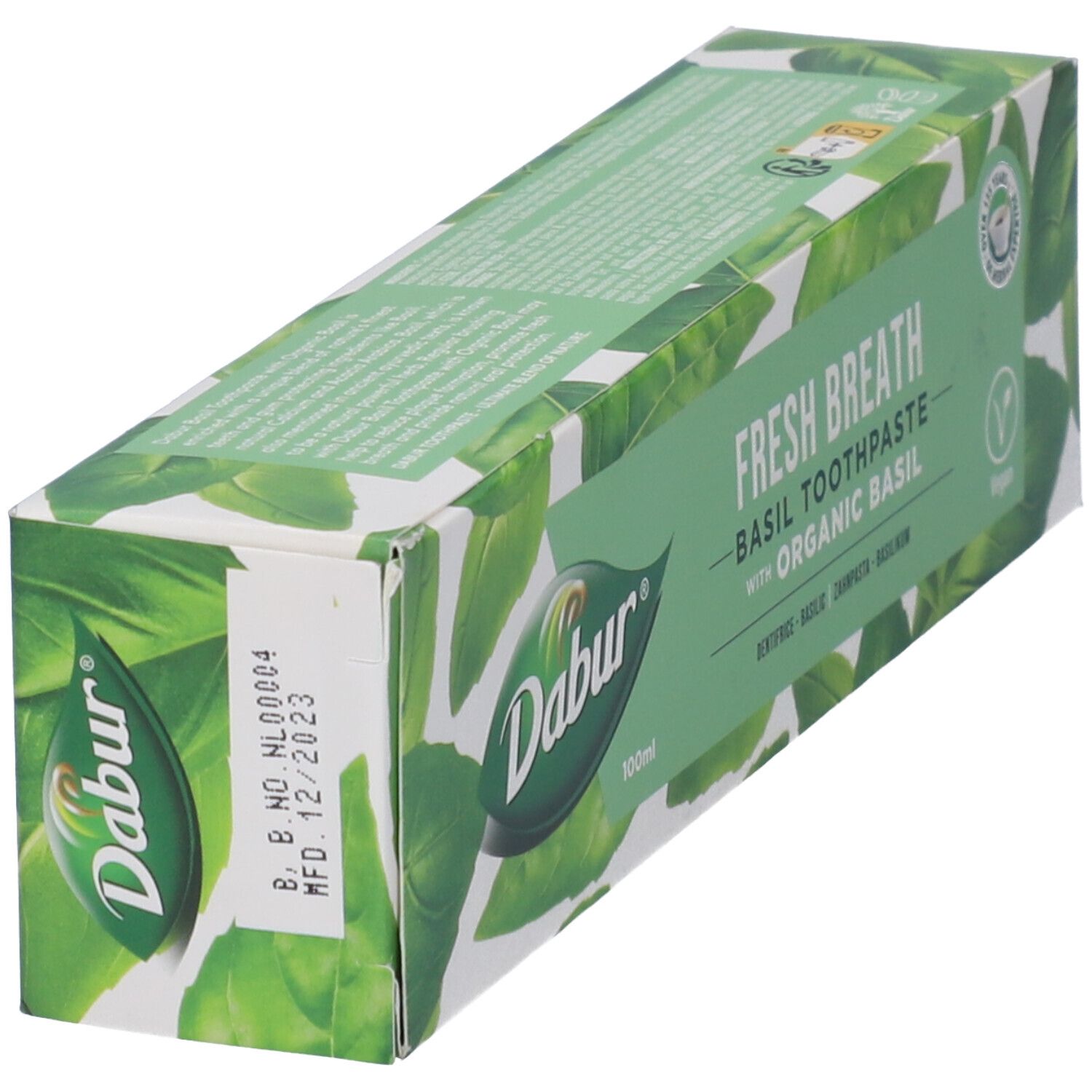 Confezione di dentifricio "Dabur Herbal" al basilico. Scatola turchese e bianca, in diagonale. Nome e logo visibili.