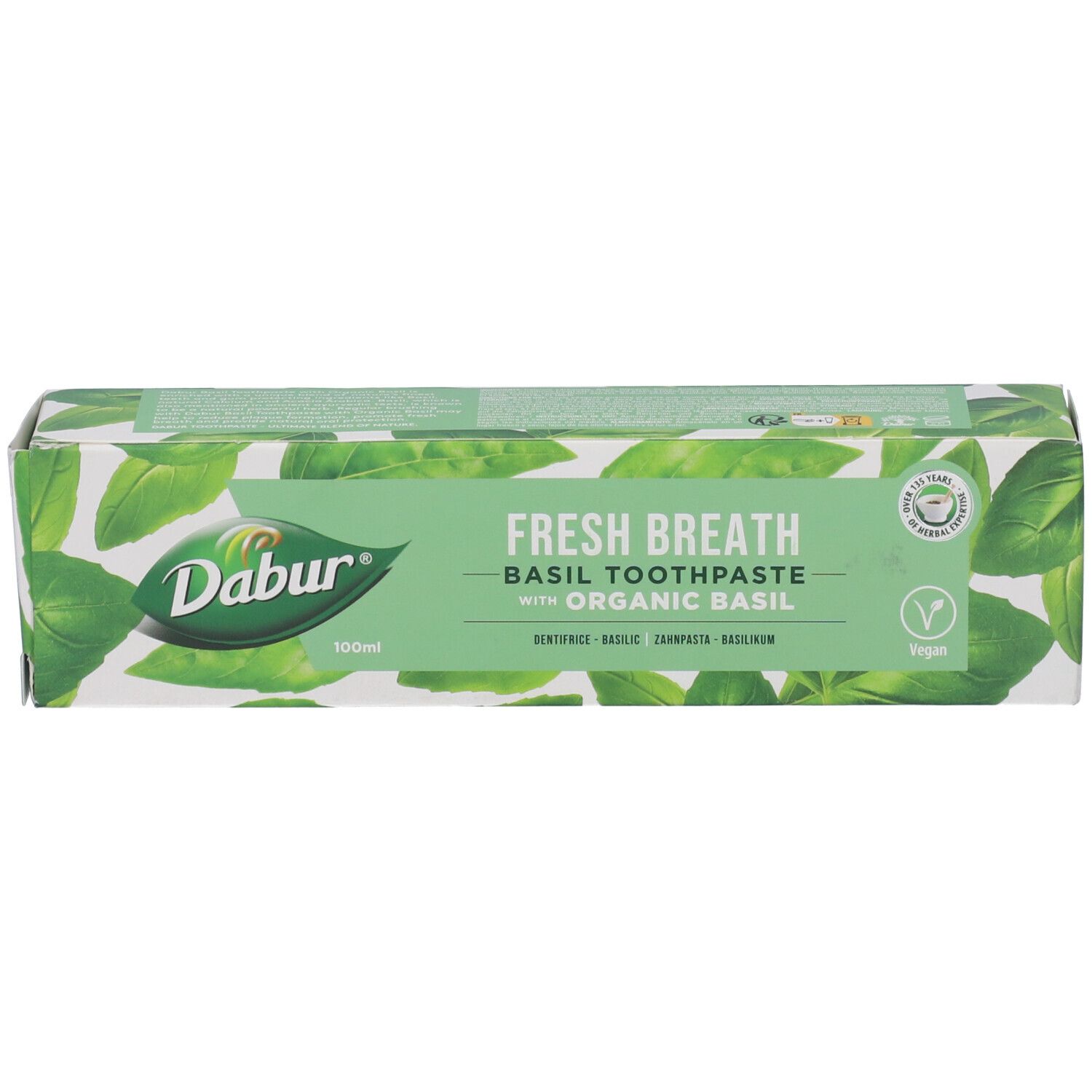 Confezione di dentifricio "Dabur Herbal" al basilico. Scatola turchese e bianca con nome e logo.