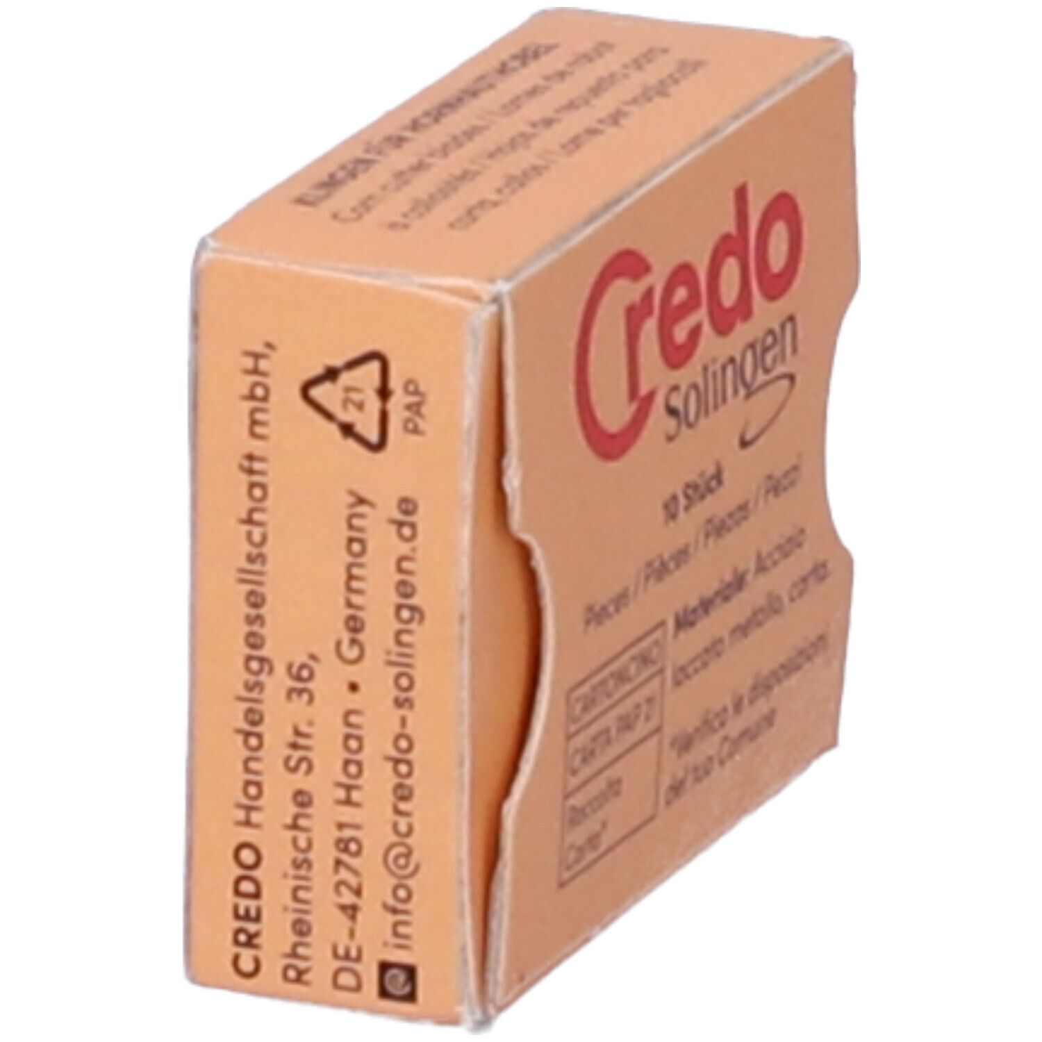 Scatola di cartone beige con logo Credo rosso. Contiene 10 pezzi. Indirizzo del produttore. Simbolo di riciclaggio. Testo multilingue.