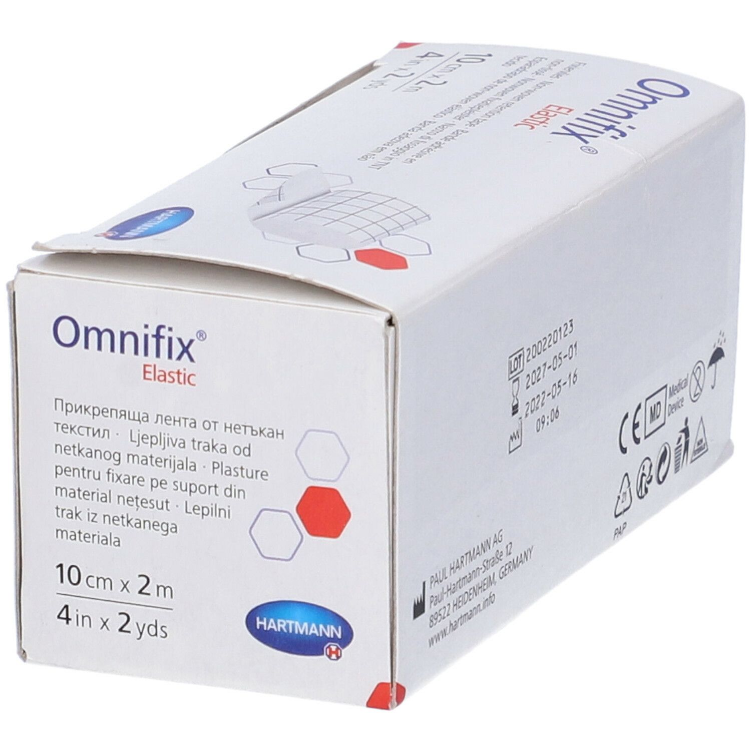 Confezione di Omnifix Elastic. Scritto: 10 cm x 2 m, 4 in x 2 yds. Marchio Hartmann. Prodotto parzialmente visibile.