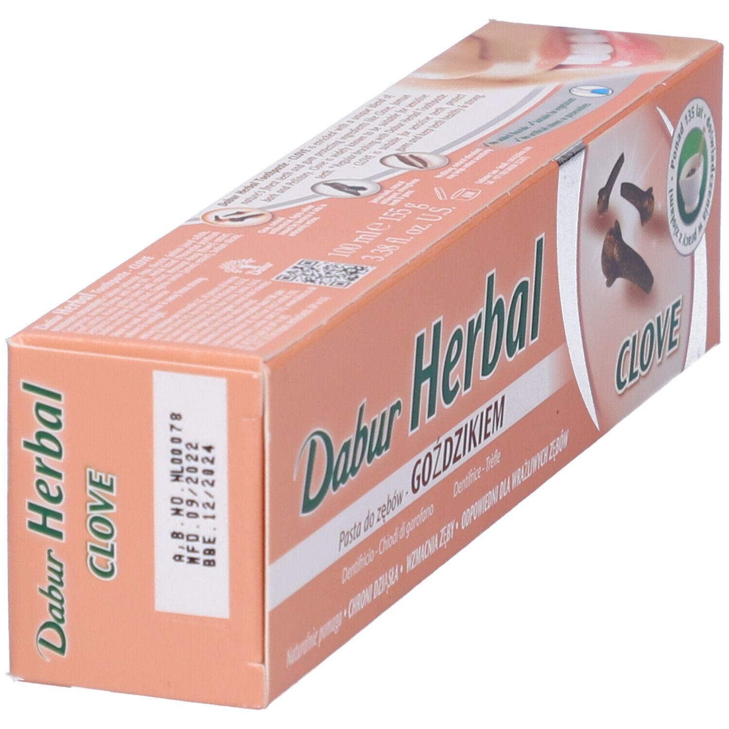 Confezione di dentifricio obliqua. Testo: Dabur Herbal, Clove. Sigillo verde: 125 anni di esperienza. Data di scadenza stampata.