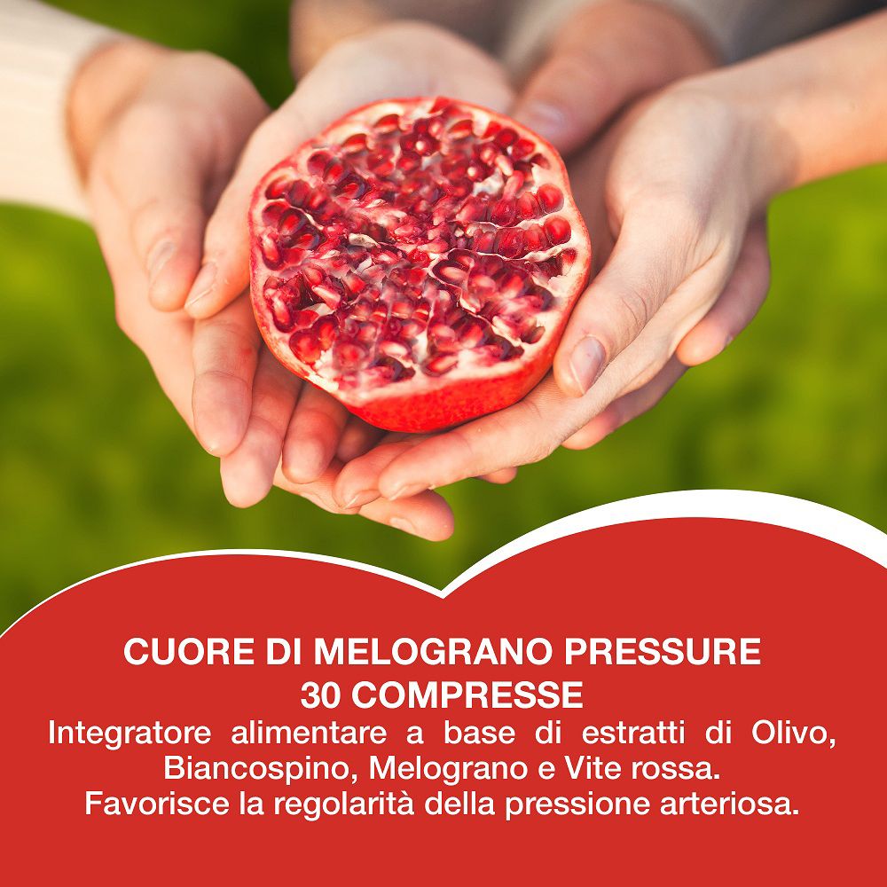 Mani che tengono una metà di melograno sopra un pannello informativo del prodotto.