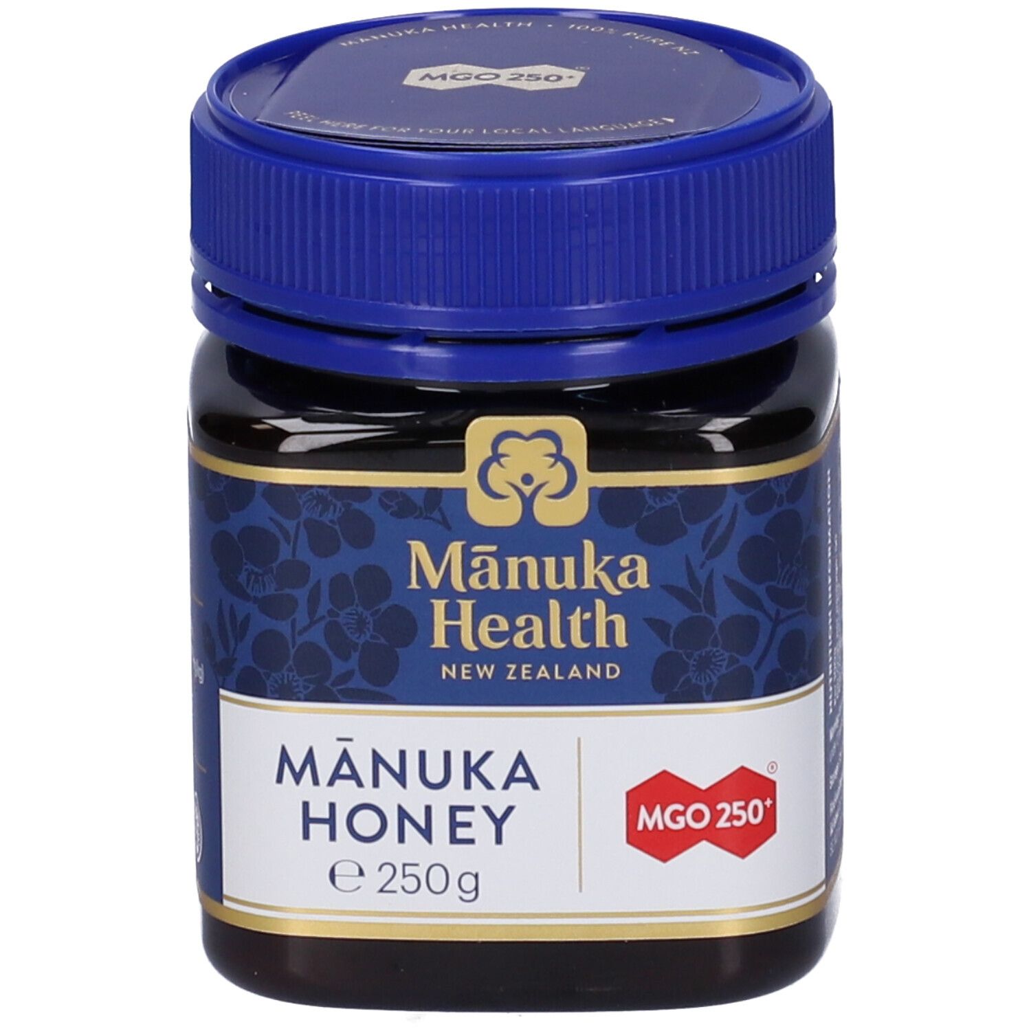 Vasetto di miele di Manuka. Etichetta blu con logo e informazioni. Coperchio blu.