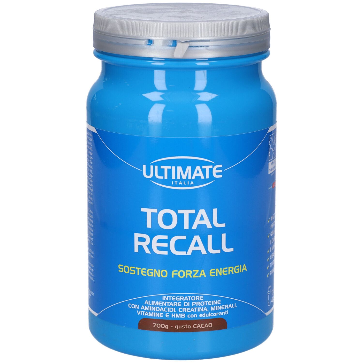 Barattolo blu con coperchio argentato. Scritta: ULTIMATE, TOTAL RECALL, SOSTEGNO FORZA ENERGIA. 700g - gusto CACAO. Contiene 30g proteine, 4g carboidrati.
