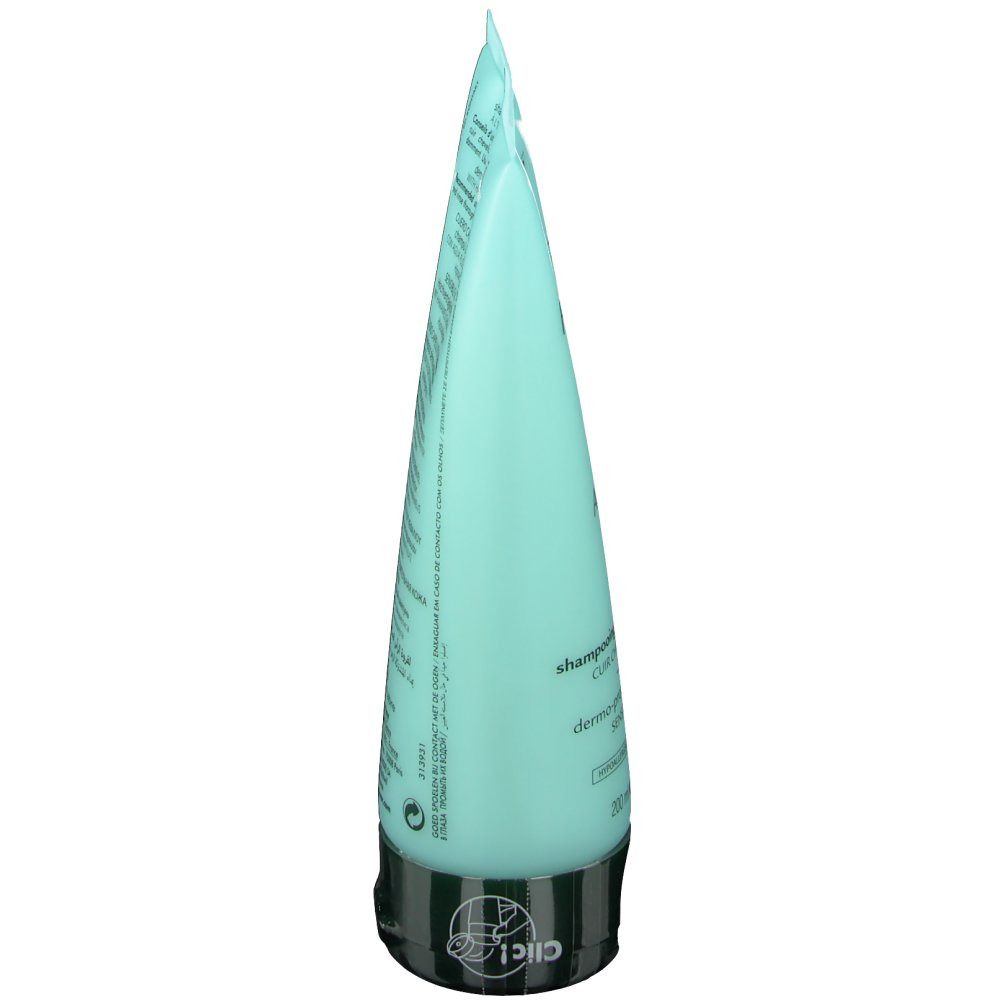 Tubo di shampoo azzurro, vista laterale. Tappo nero. Testo sul tubo.