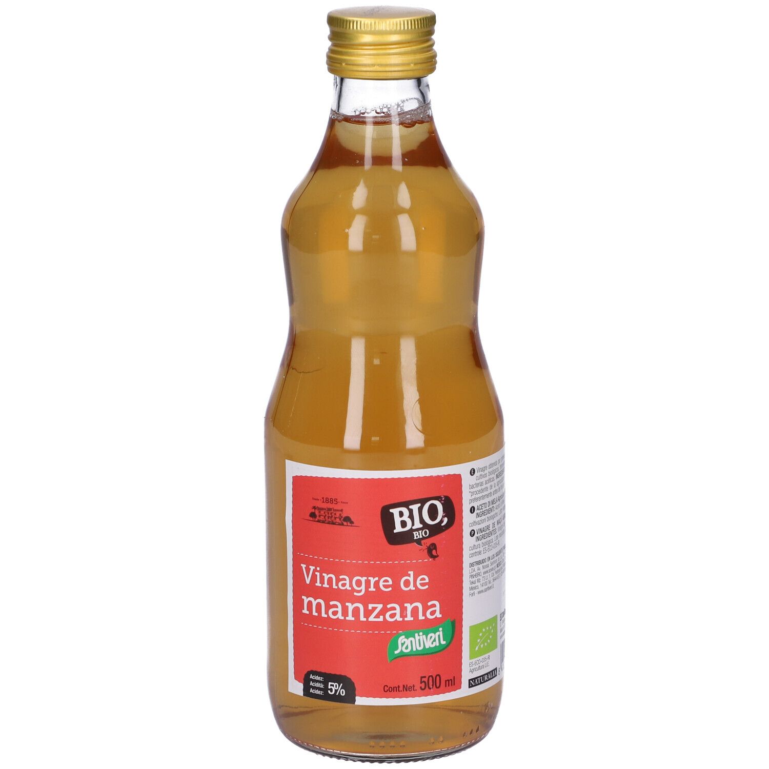 Bottiglia di vetro con liquido giallo. Tappo dorato. Etichetta rossa con testo: Vinagre de manzana.