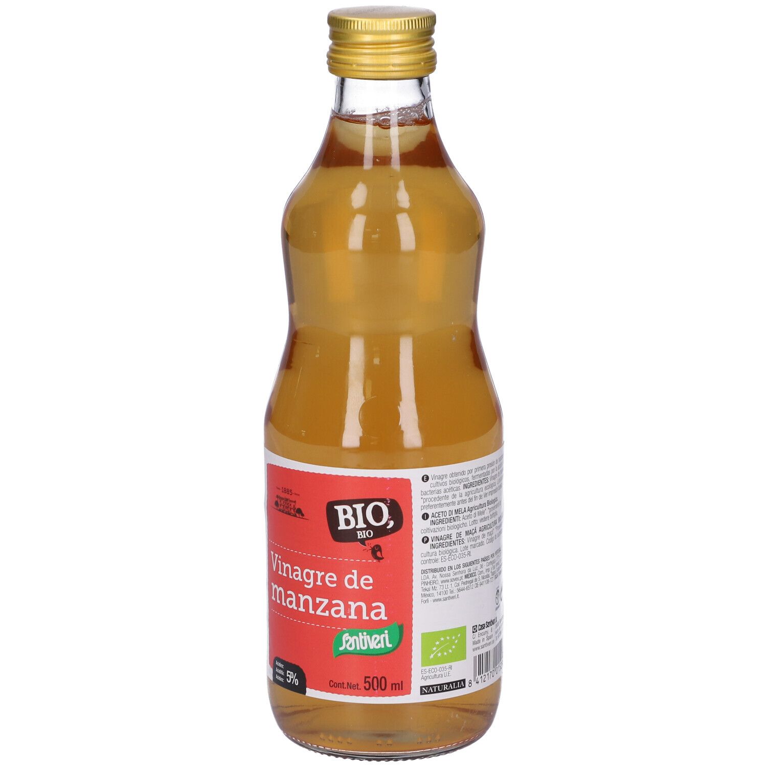 Bottiglia di vetro con liquido giallo. Tappo dorato. Etichetta rossa con testo: Vinagre de manzana.