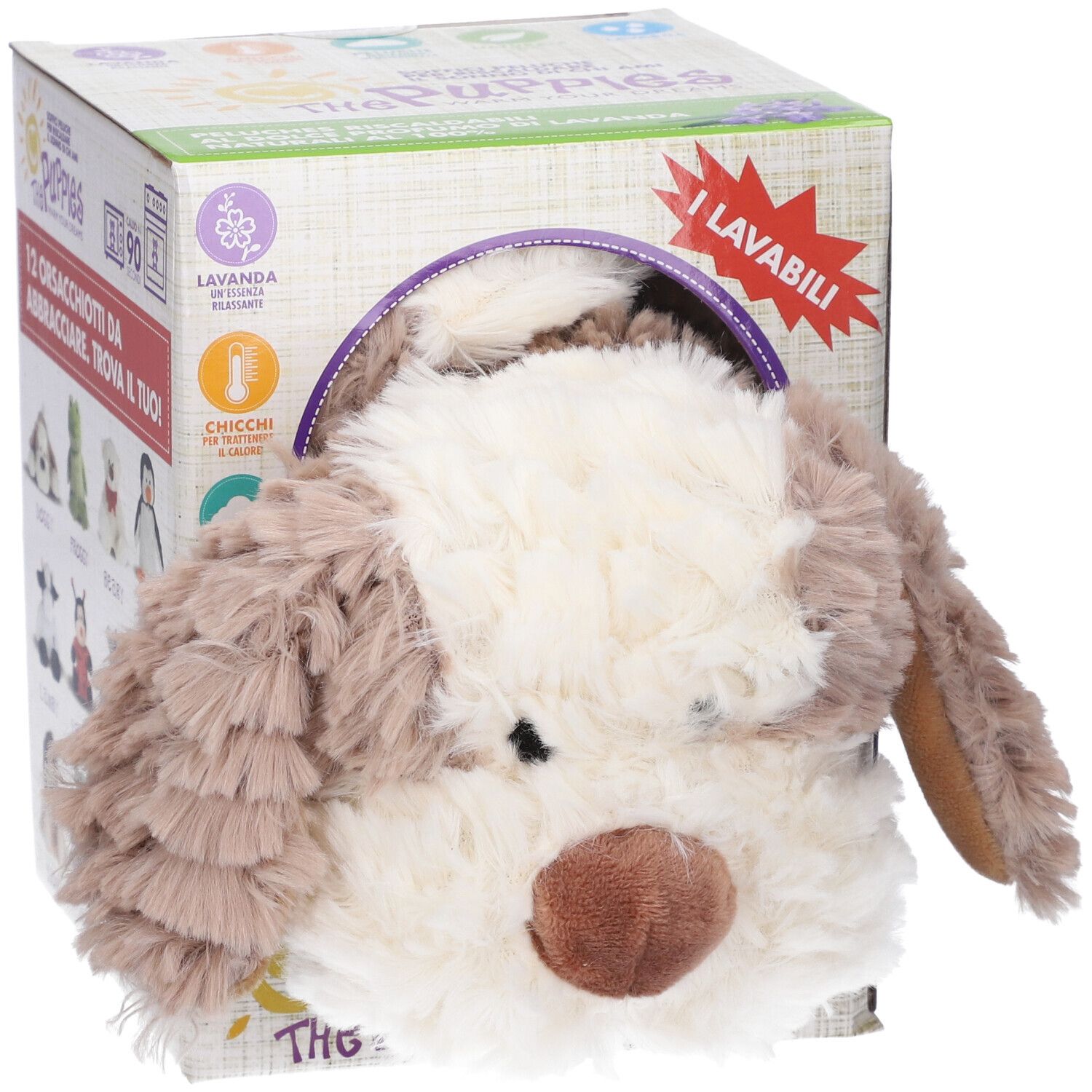 Cagnolino di peluche parzialmente in una scatola di cartone. La scatola mostra informazioni sul prodotto e il logo "The Puppies".