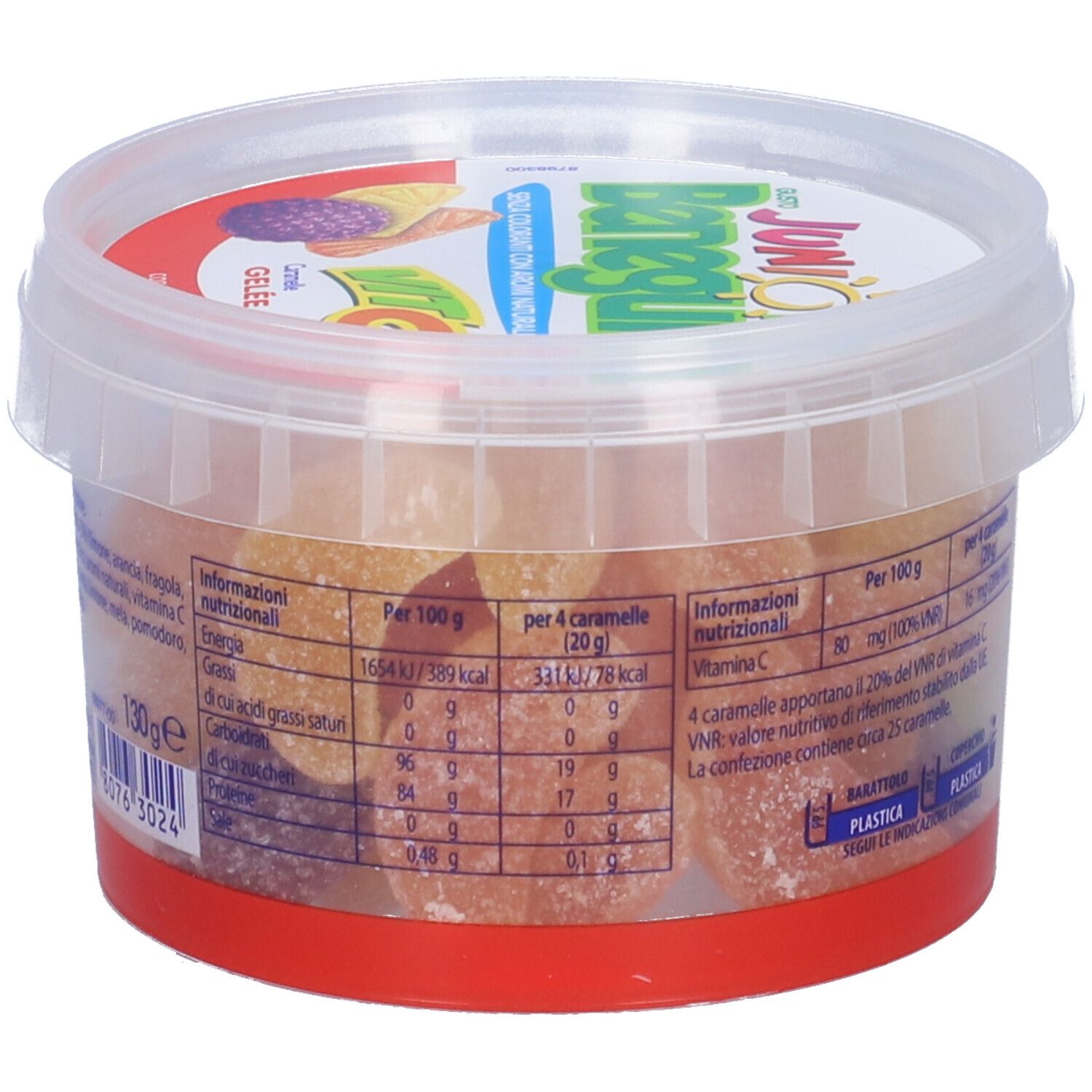 Barattolo trasparente con caramelle gommose. Scritta "Junior Benegum Vit C". Informazioni nutrizionali sul barattolo. Caramelle gommose visibili.