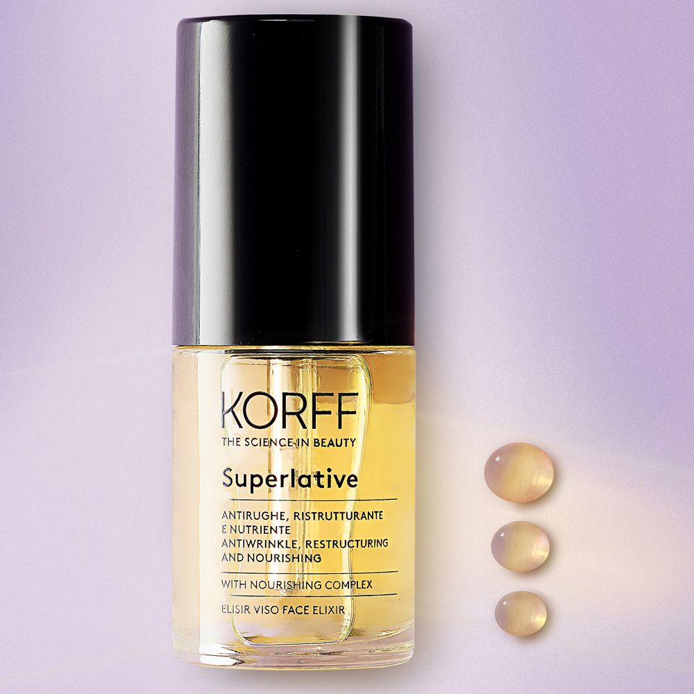 Elixir viso KORFF Superlative. Flacone nero. Liquido giallo e gocce visibili.