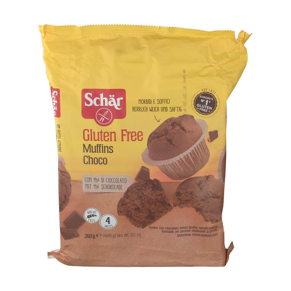 Confezione gialla Schar® Gluten Free Muffins Choco. Immagini di muffin e pezzi di cioccolato. Contiene 4 pezzi. Sigillo senza glutine.