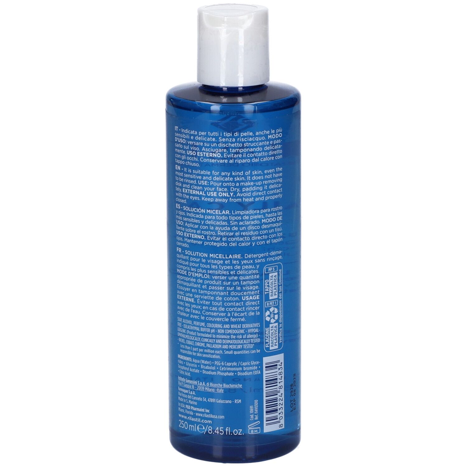 Retro del flacone blu con tappo bianco. Testo multilingue. Ingredienti e istruzioni per l'uso.