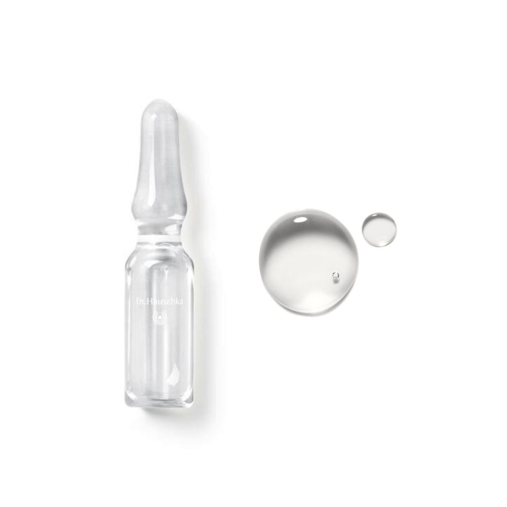 Fiala di vetro e due gocce di liquido. Su sfondo bianco.