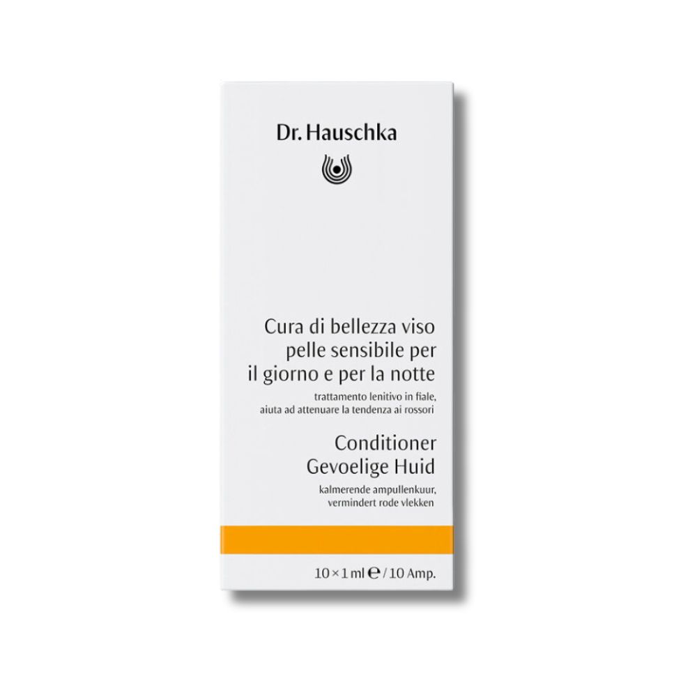 Scatola bianca con informazioni sul prodotto. Striscia arancione in basso.