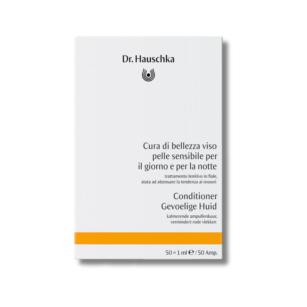 Confezione bianca con informazioni sul prodotto. Striscia gialla in basso. Logo Dr. Hauschka.