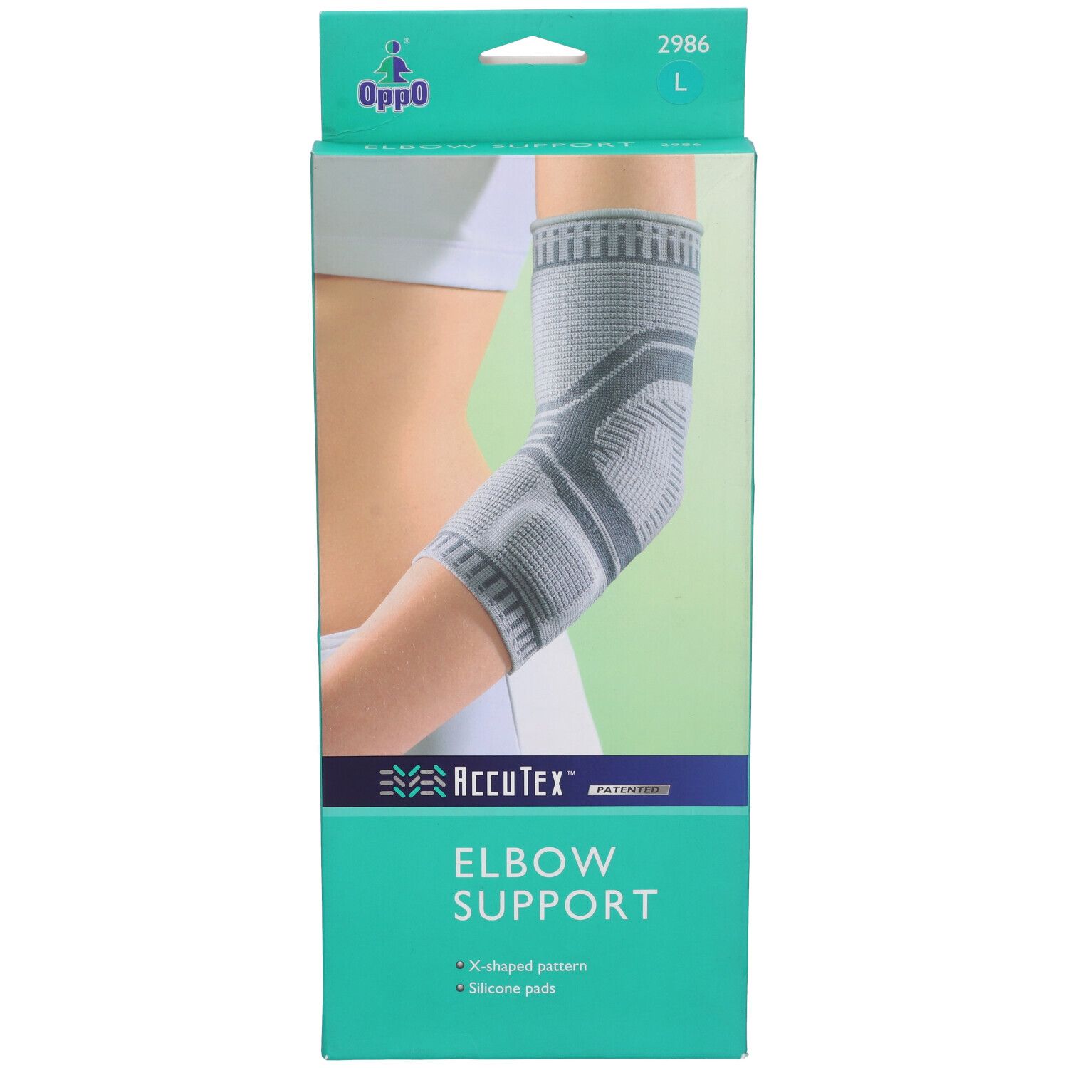 Supporto per gomito Oppo 2986 L. AccuTex Elbow Support. Motivo a X e cuscinetti in silicone. Indossato.