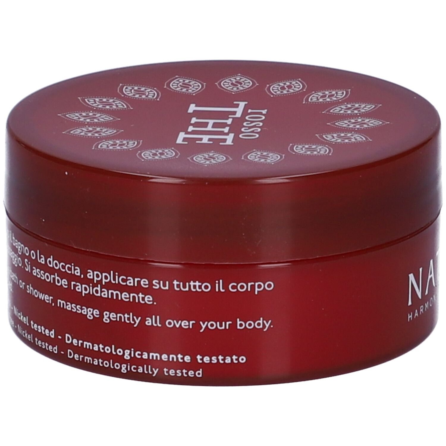 Vaso di crema rossa. Scritte: Nature's, Rosso The, Crema Corpo Detossinante. Istruzioni per l'uso.