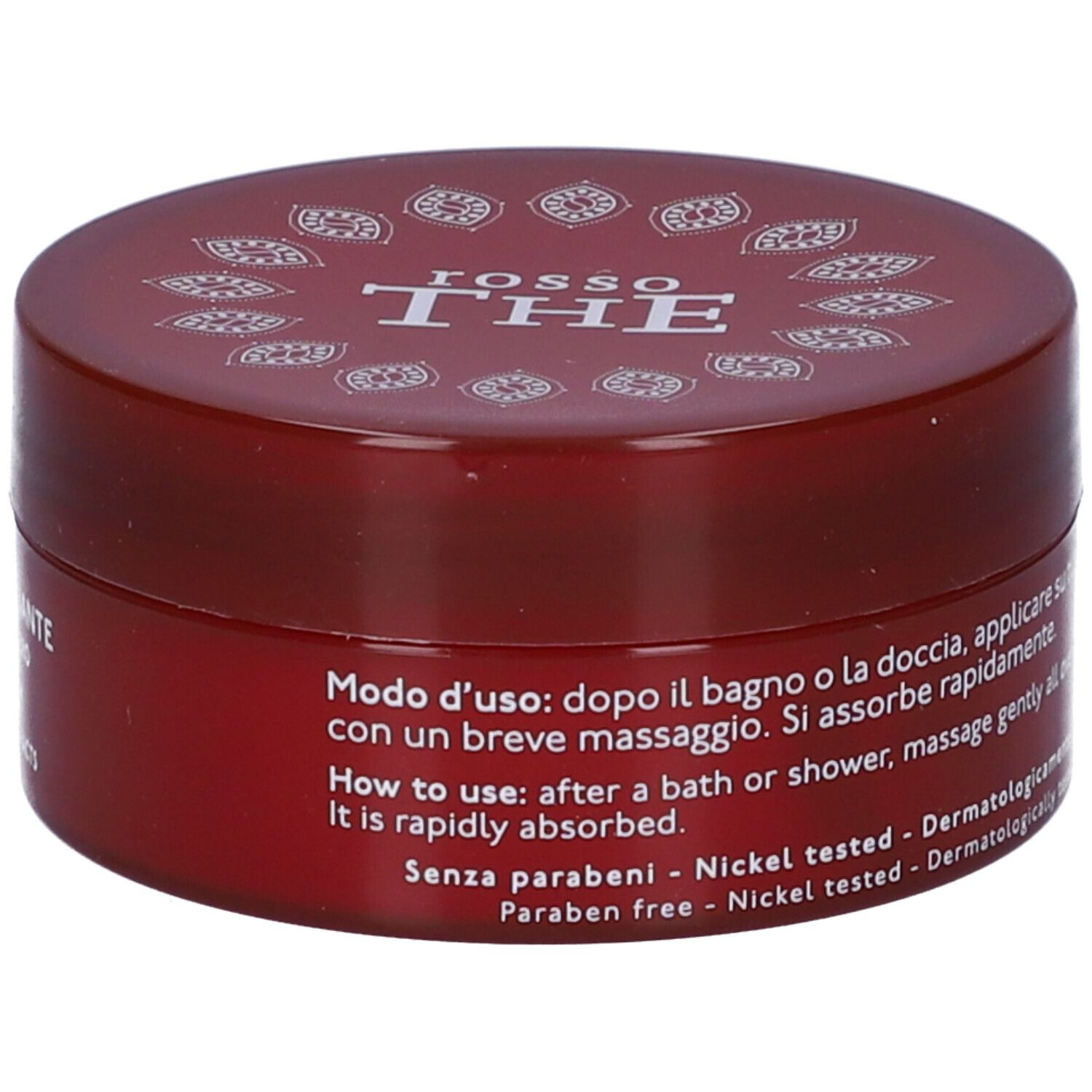Vaso di crema rossa. Scritte: Nature's, Rosso The, Crema Corpo Detossinante. Istruzioni per l'uso.