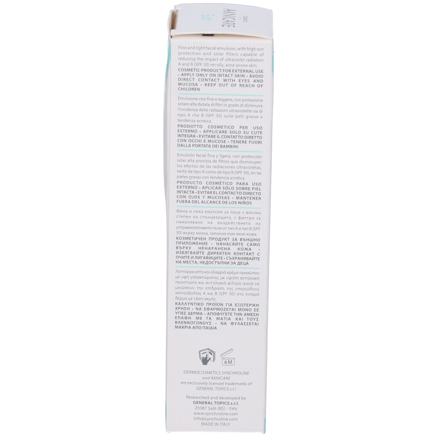 Retro della scatola bianca. Testo multilingue. Informazioni sul produttore e simbolo 6M.