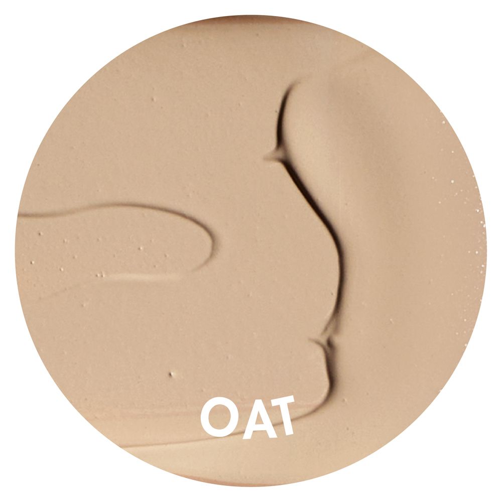 Macchia rotonda di correttore color OAT. La consistenza è cremosa e marrone chiaro.