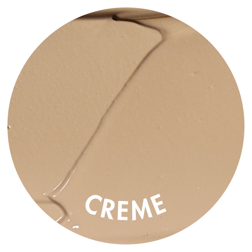 Macchia rotonda di correttore crema. Scritta: CREME. Tonalità.