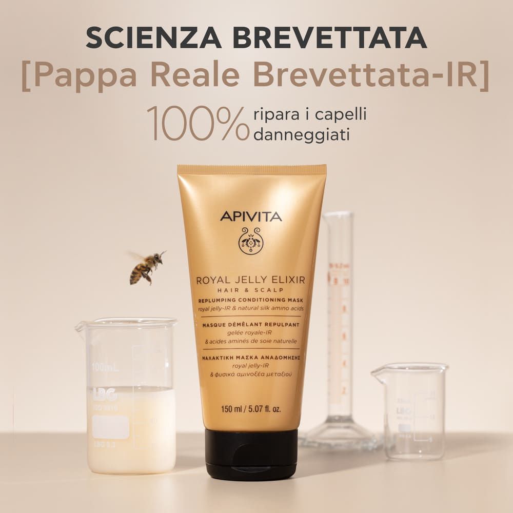 Tubo dorato con tappo nero accanto ad attrezzature di laboratorio. Testo: [Pappa Reale Brevettata-IR] 100% riparare i capelli danneggiati.