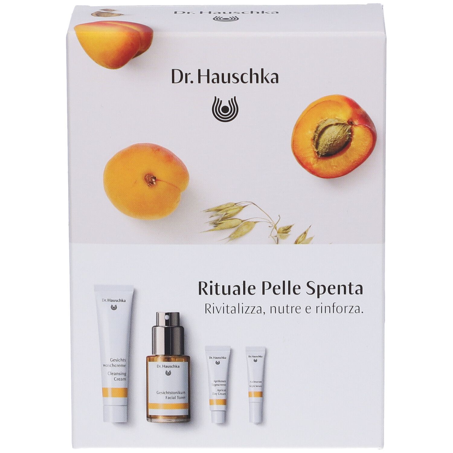 Confezione di cosmetici. Scritte: Dr. Hauschka, Rituale Pelle Spenta. Prodotti e immagini di albicocche.