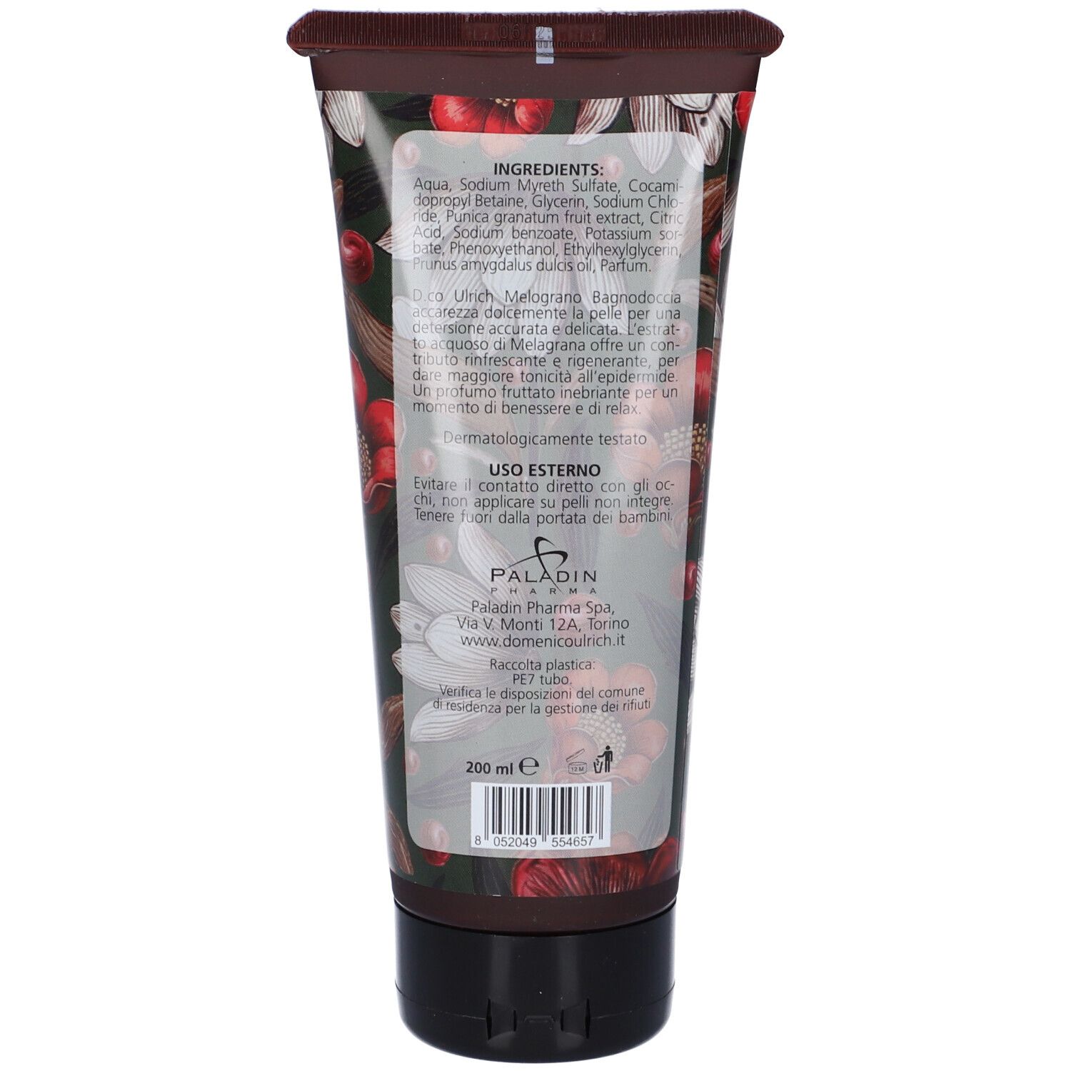 Retro del tubo. Contiene ingredienti, istruzioni per l'uso e informazioni sul produttore. Tappo nero, sfondo marrone.