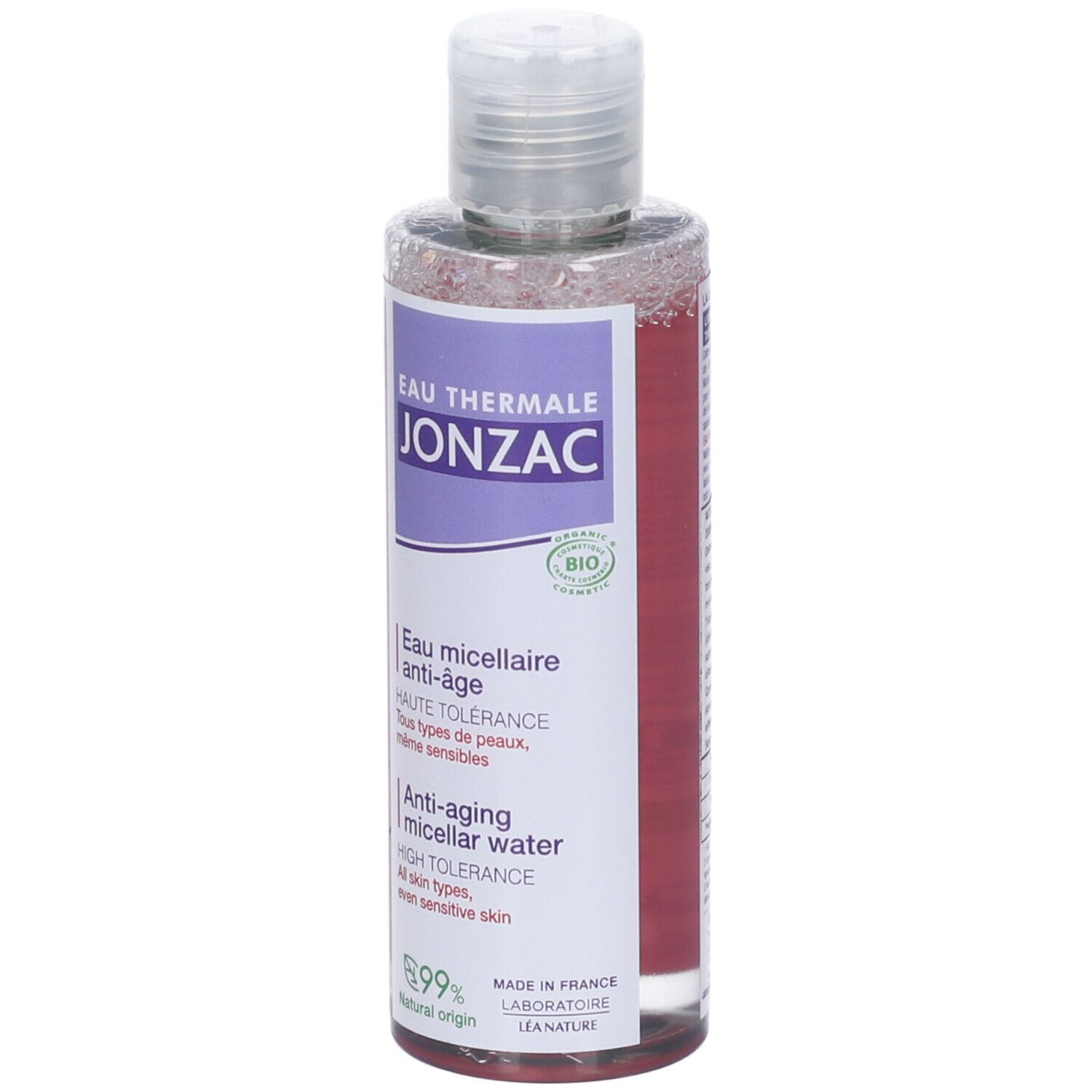 Flacone trasparente con etichetta viola. Testo: JONZAC, Eau Thermale, Anti-âge. Certificazione bio. Tappo e collo trasparenti.