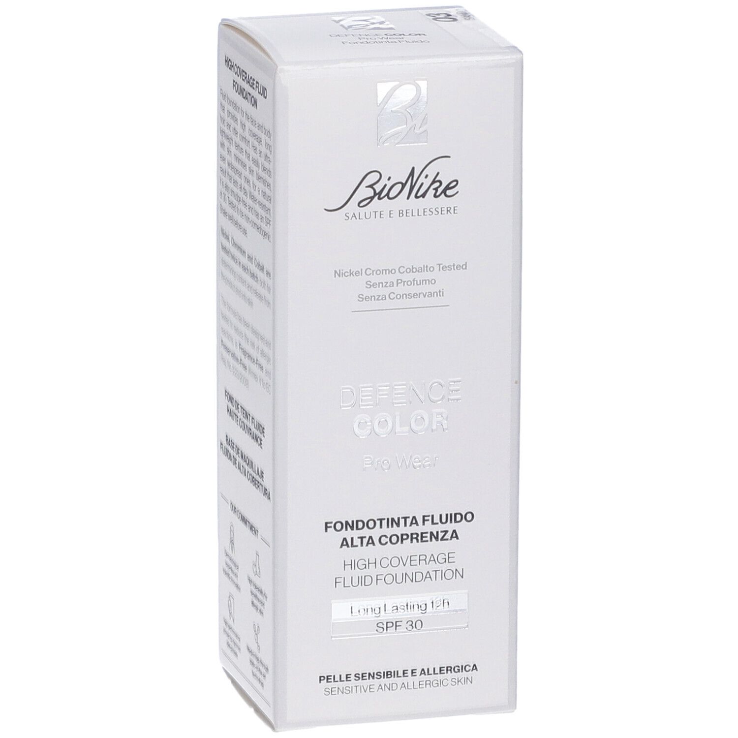 Scatola bianca con informazioni prodotto. Marchio Bionike, scritta 'Defence Color'. Testo: 'Fondotinta Fluido Alta Coprenza'.