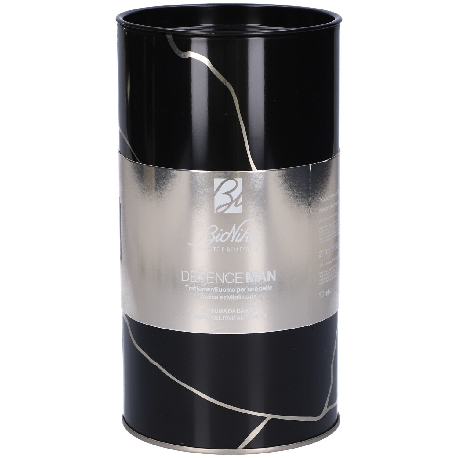 Confezione cilindrica nera con fascia argento. Scritta "Defence Man", logo e informazioni prodotto.