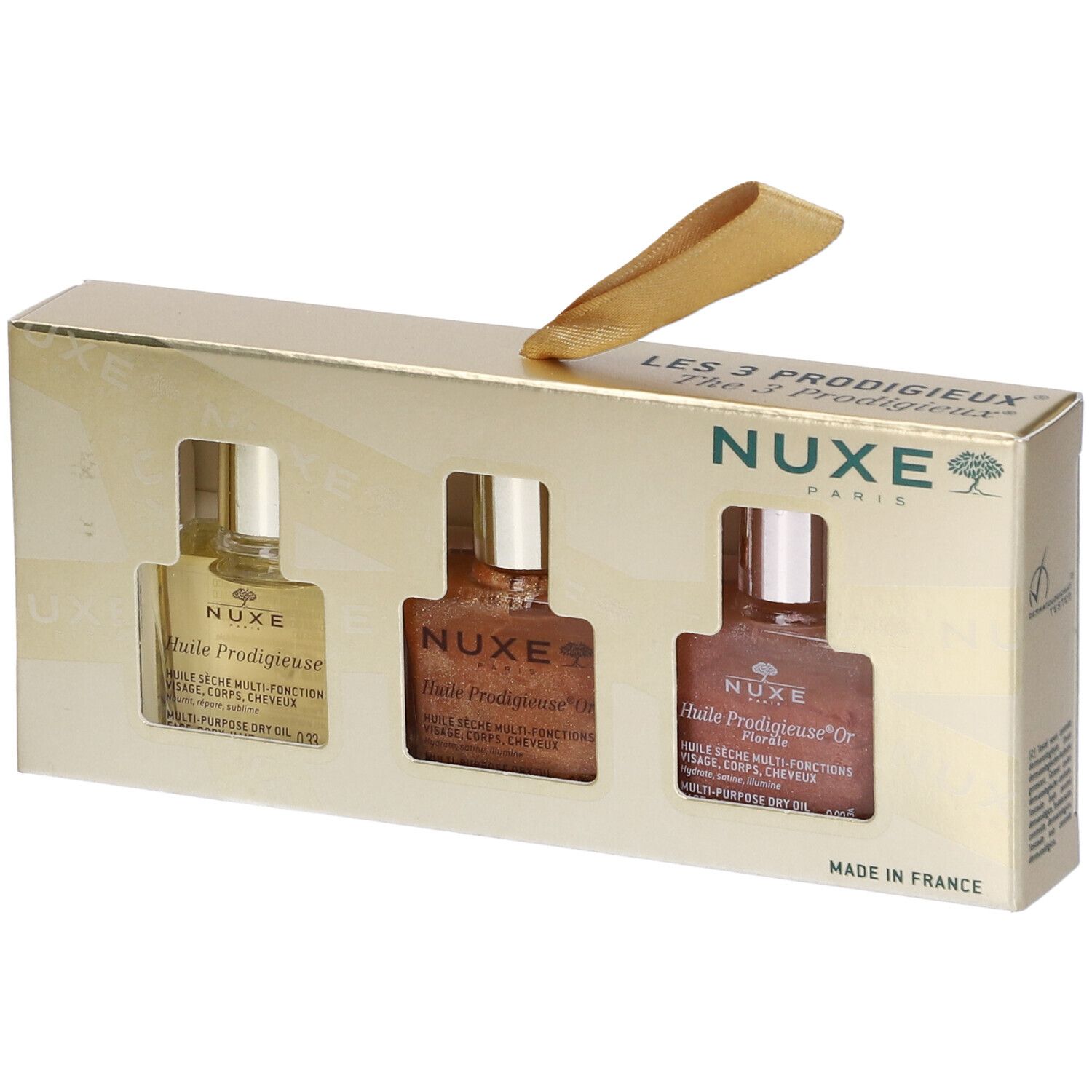 Confezione regalo con tre mini oli. Confezione dorata con finestre. Logo Nuxe e nomi dei prodotti.