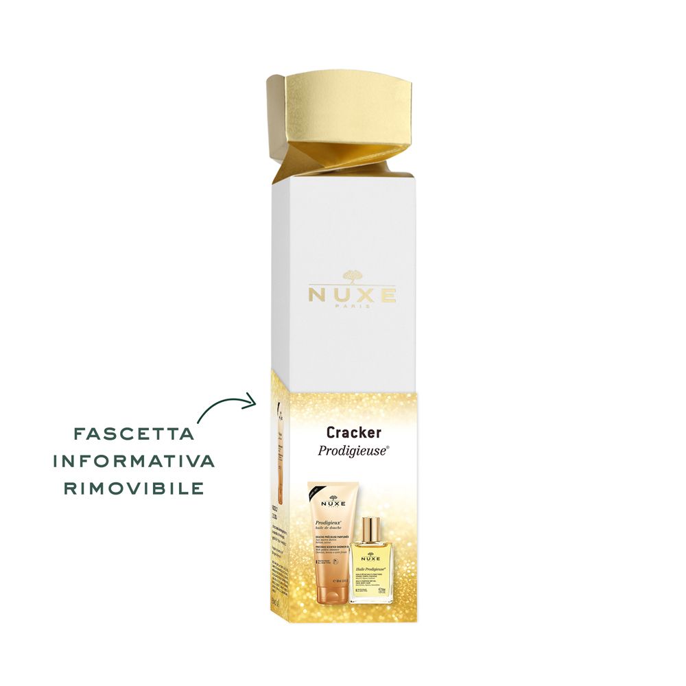 Confezione regalo con prodotti Nuxe. Scritta: Cracker Prodigieuse. Sulla scatola sono raffigurati un tubo e un flacone. Testo: Fascetta informativa rimovibile.
