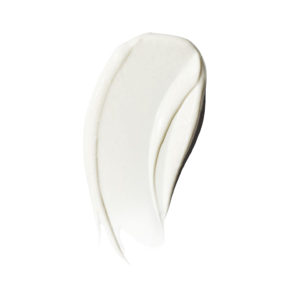 Traccia di crema bianca su sfondo bianco. Visibile la consistenza della crema.