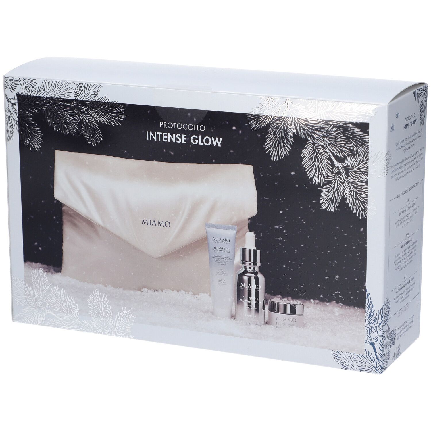 Scatola bianca con motivo rami di pino blu argento. Interno: cosmetici e pochette. Scritta: MIAMO PROTOCOLLO INTENSE GLOW.