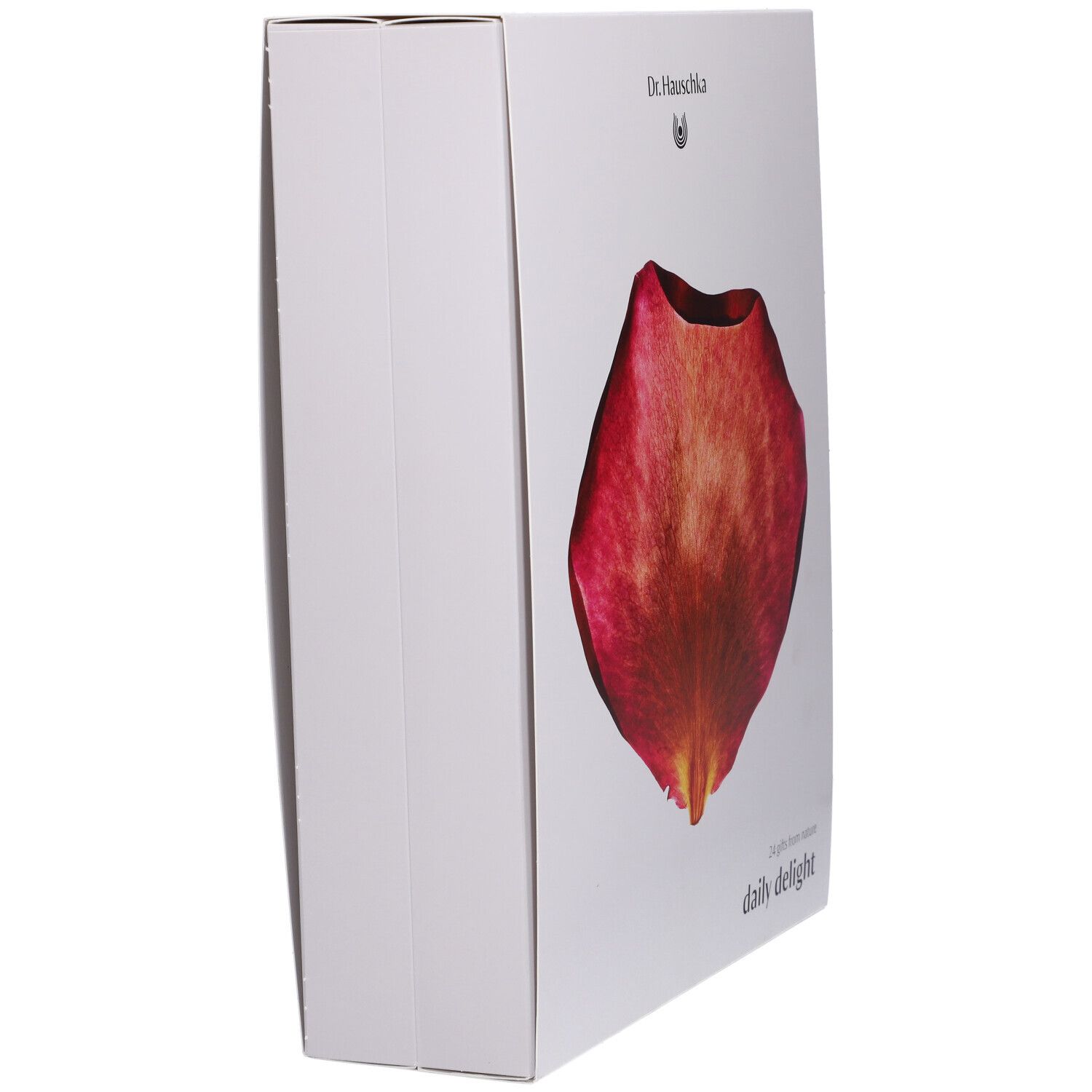Scatola bianca con un petalo rosso. Sul lato "Dr. Hauschka" e "daily delight".