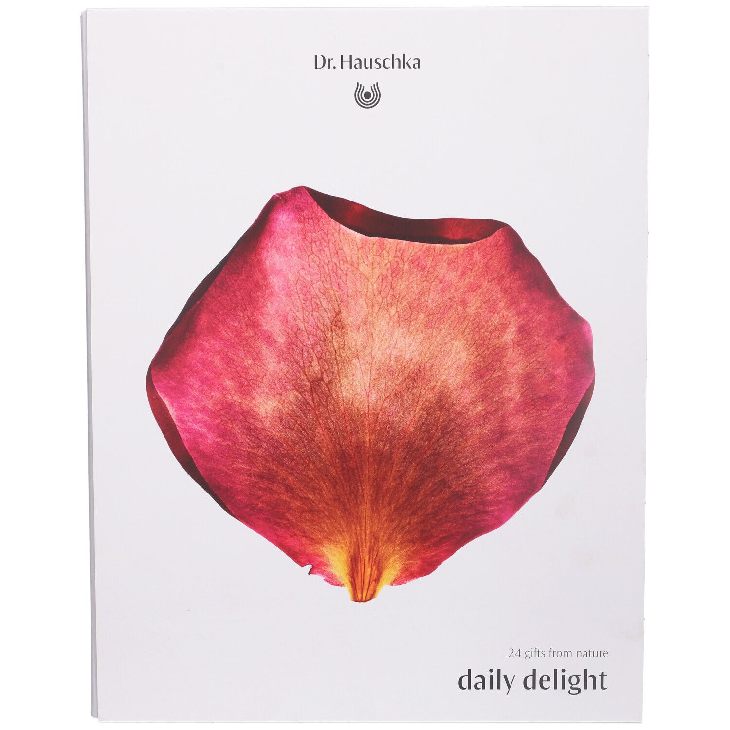 Scatola bianca con un petalo rosso. In alto "Dr. Hauschka". In basso "daily delight".