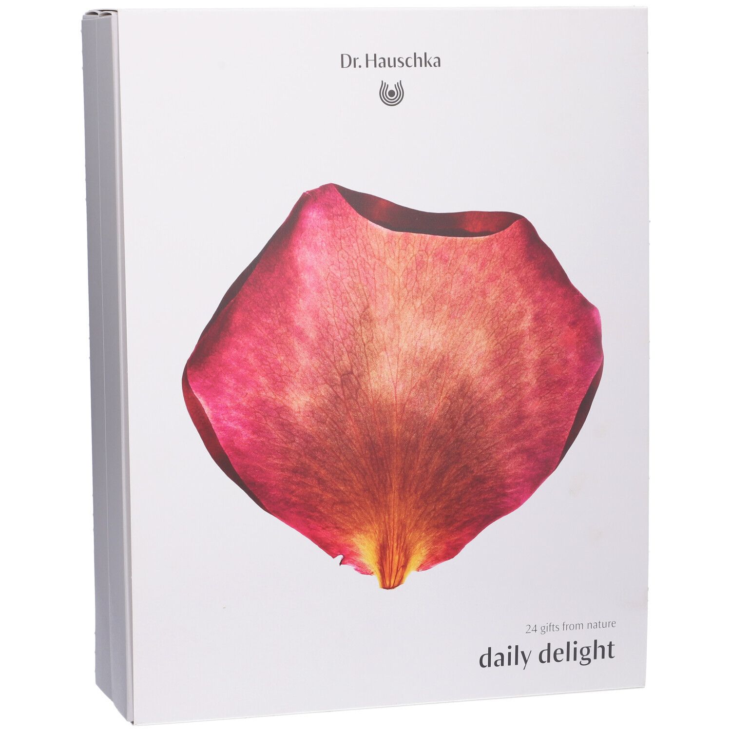 Scatola bianca con un petalo rosso. In alto "Dr. Hauschka". In basso "daily delight".