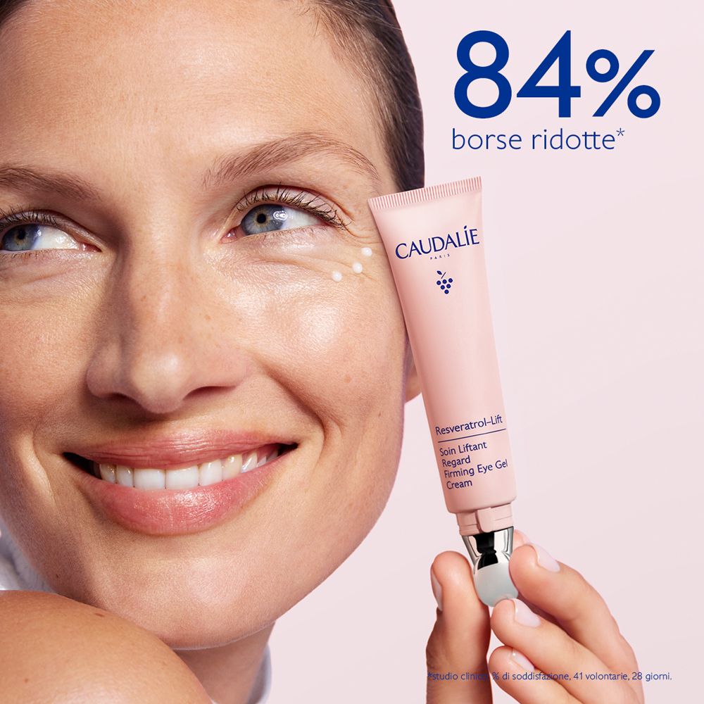 Donna con tubetto di crema occhi. Testo: 84% borse ridotte. Prodotto Caudalie.