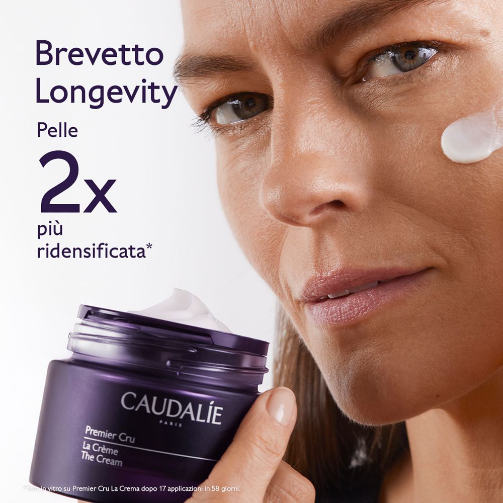 Donna con crema. Testo: 2x più densità della pelle. Crema Caudalie Premier Cru. Vasetto di crema.