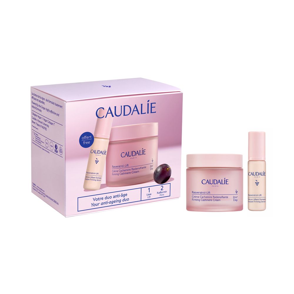 Set rosa Caudalie con crema, siero e uva. Scatola con logo e testo. Due creme e un siero.