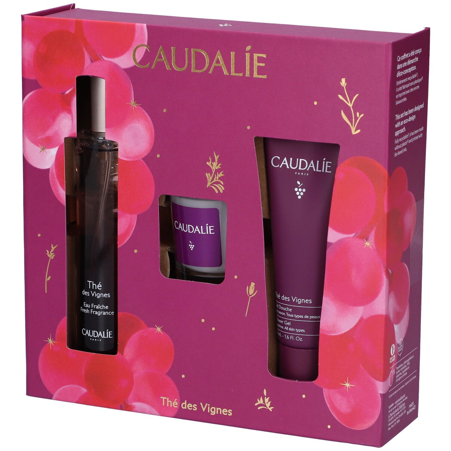 Set regalo con flacone, candela e tubo. Confezione viola con motivo floreale. Logo Caudalie.