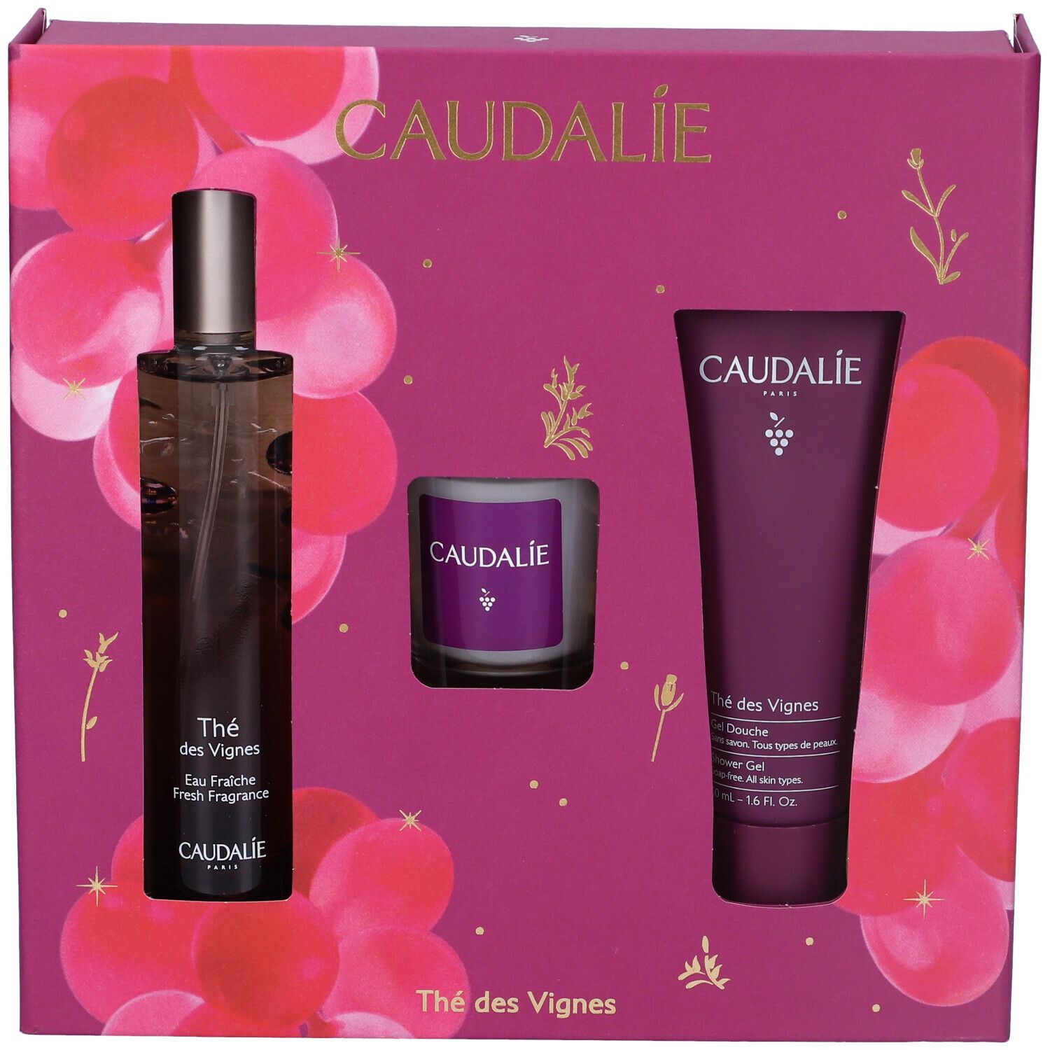 Set regalo con flacone, candela e tubo. Confezione viola con motivo floreale. Logo Caudalie.