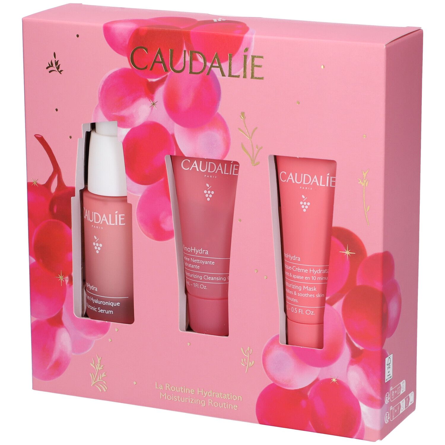 Confezione rosa Caudalie con siero, gel detergente e maschera. Sfondo con motivi di uva.