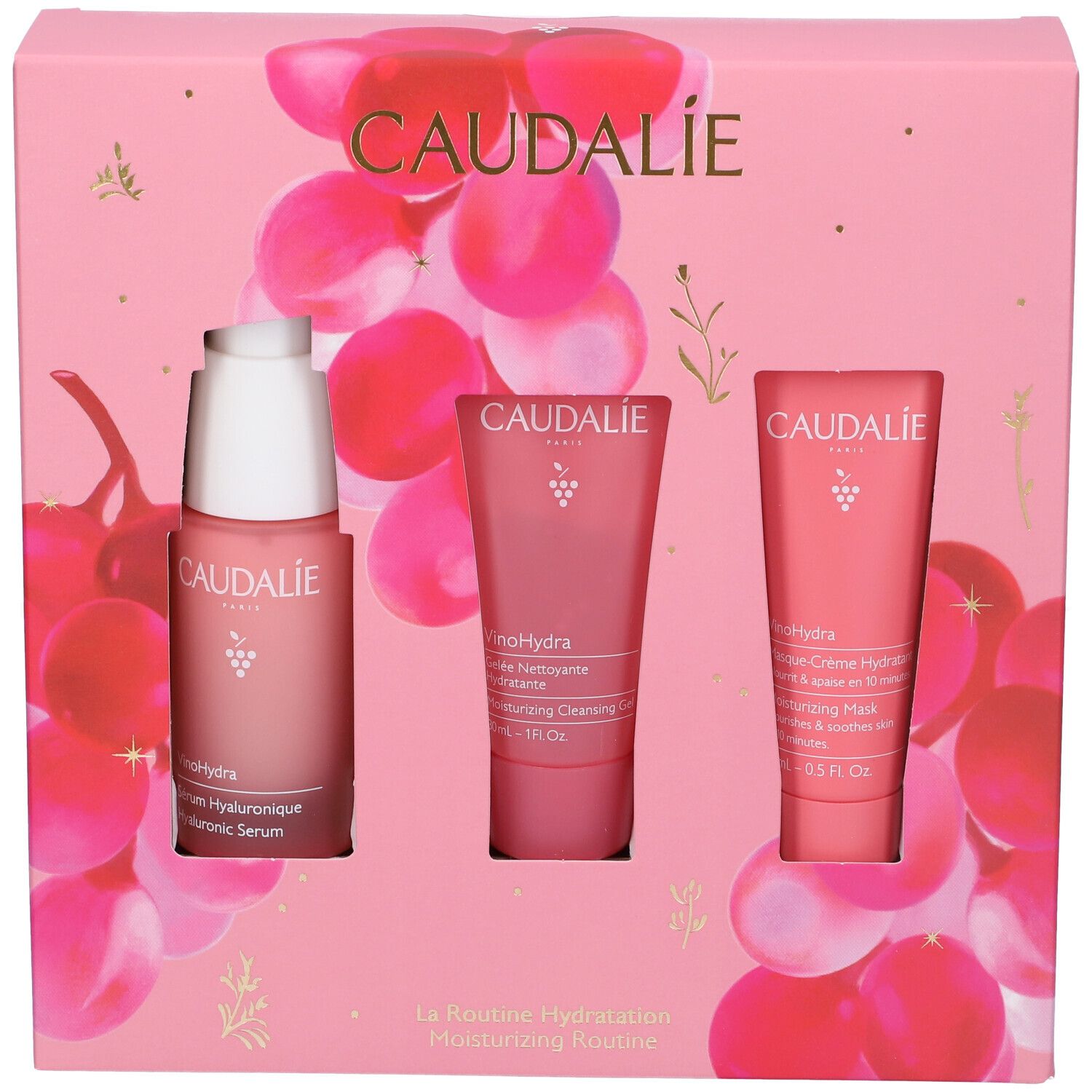 Confezione rosa Caudalie con siero, gel detergente e maschera. Sfondo con motivi di uva.