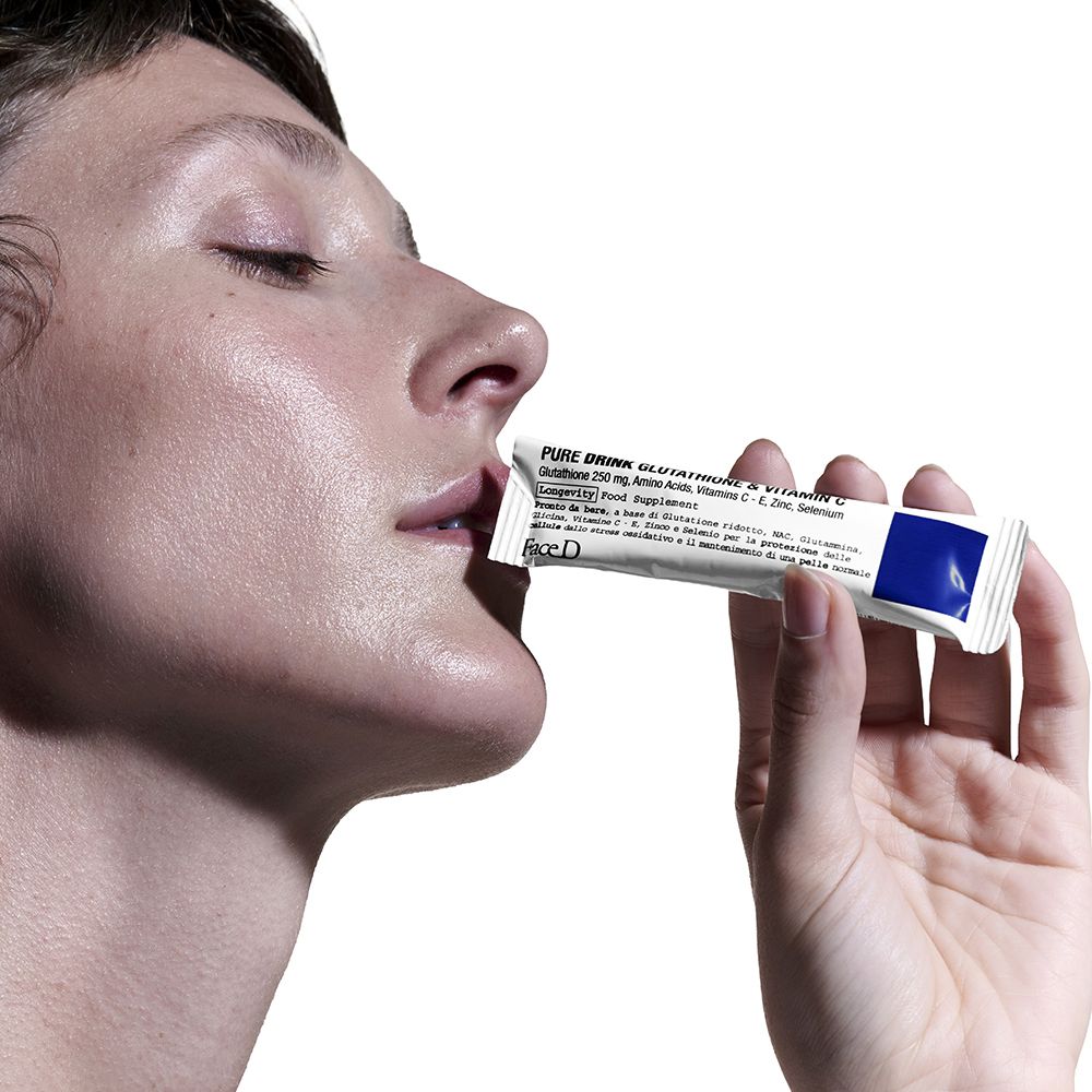 Bustina bianca con area blu. Scritta: 'PURE DRINK GLUTATHIONE & VITAMIN C', FaceD. Contiene integratore.