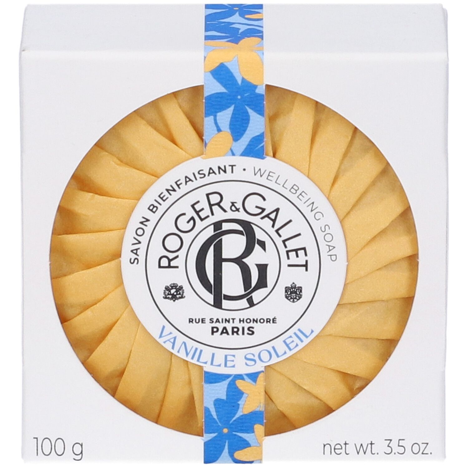 Sapone rotondo giallo in confezione bianca. Scritta: Roger & Gallet, Vanille Soleil. Con nastro blu e giallo.